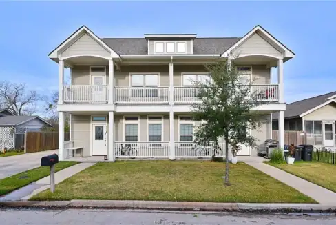Front view of a two-story residential building with balconies in Aggieland, Texas.