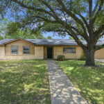 Single-story house with a large front yard and a big tree, located in Southside.